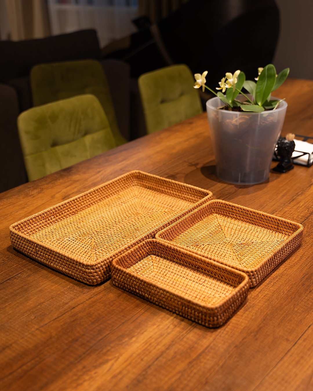 Handwoven rattan tray set styled with lemons and nuts
Rattan trays stacked on dining table
Detail shot of wicker weave texture
